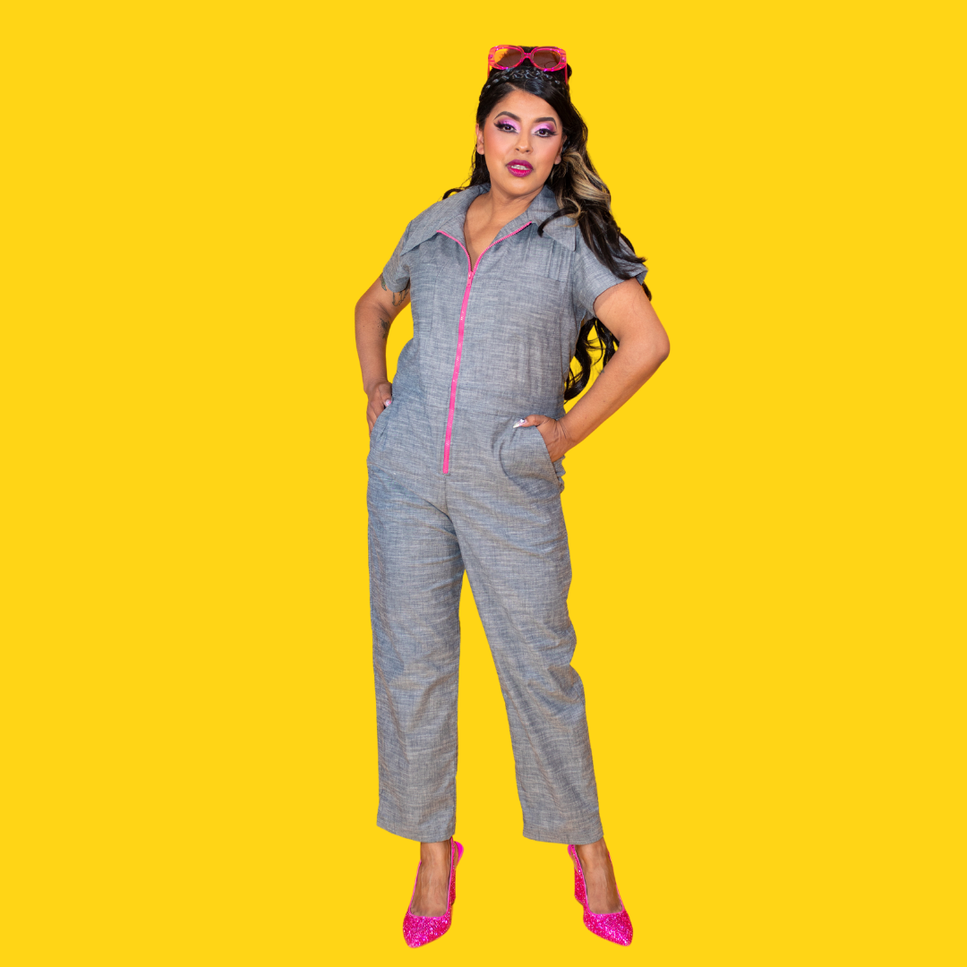Latina model wearing chambray jumpsuit with bright pink zipper