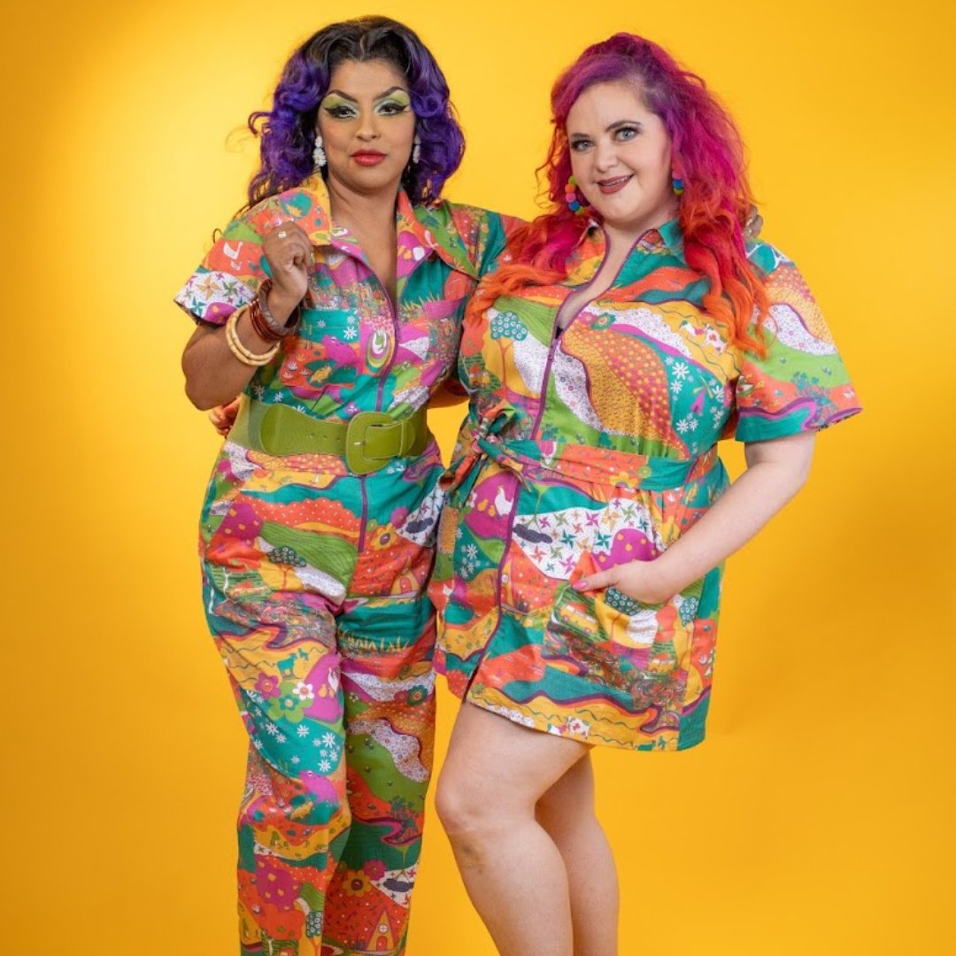 2 pretty models posing in multicolored jumpsuit and minidress