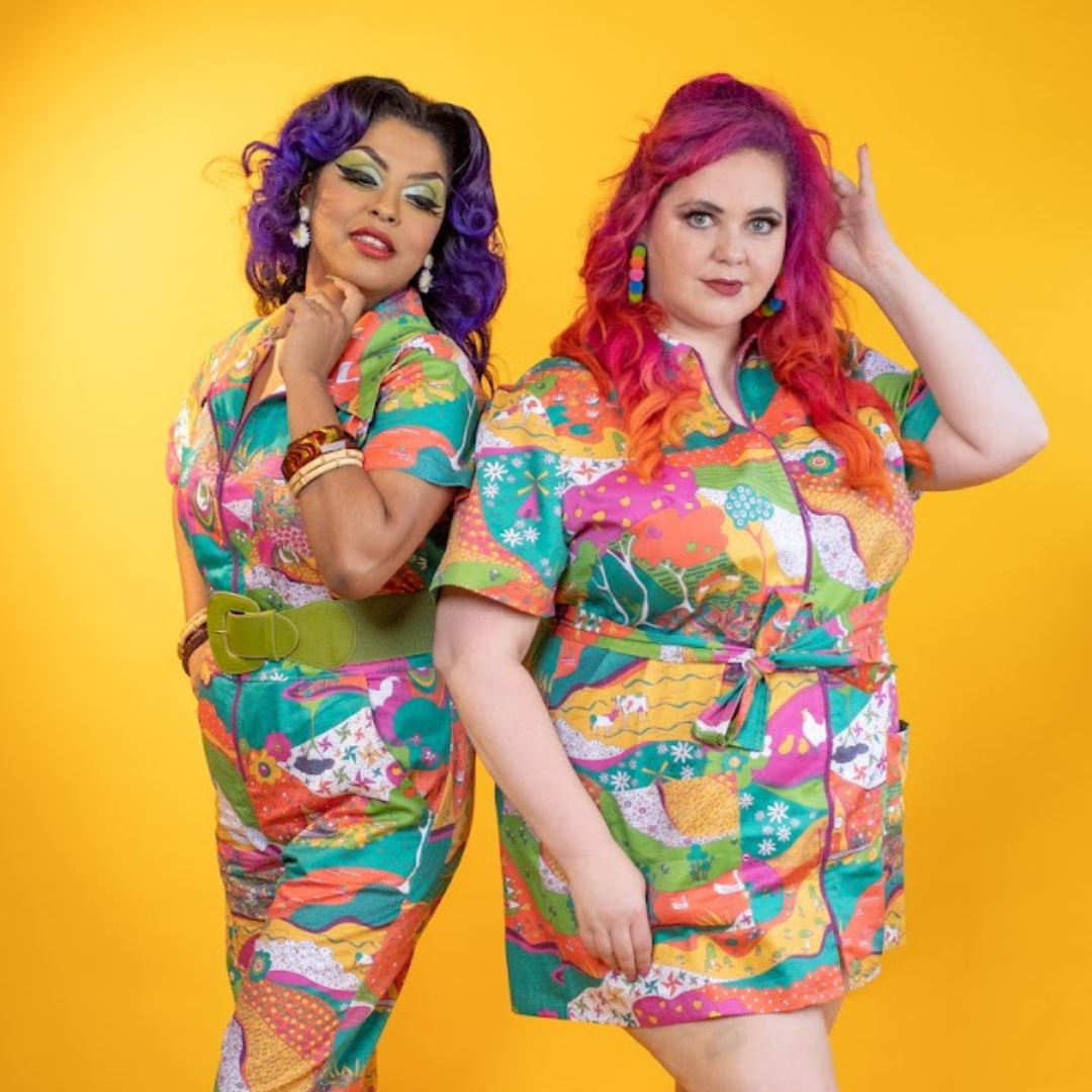 2 models back to back wearing brightly colored printed cotton clothing
