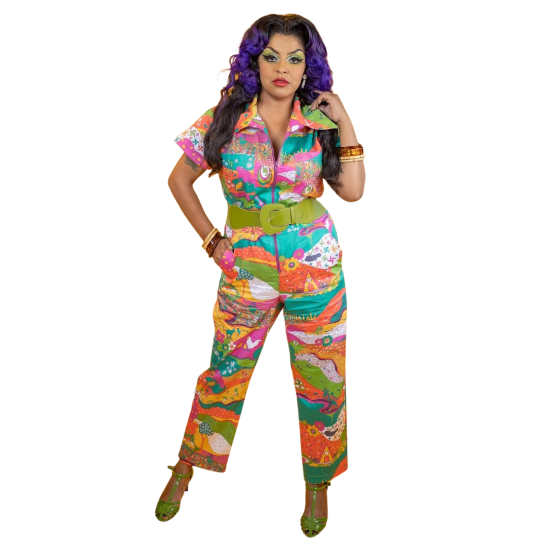 Purple-haired model wearing brightly colored patterned jumpsuit