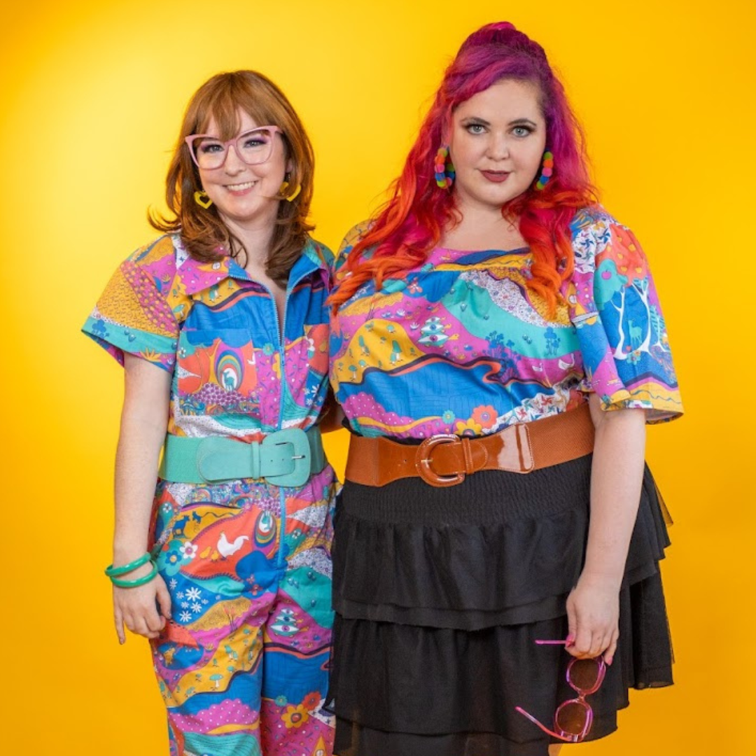 2 pretty models wearing brightly colored printed clothing