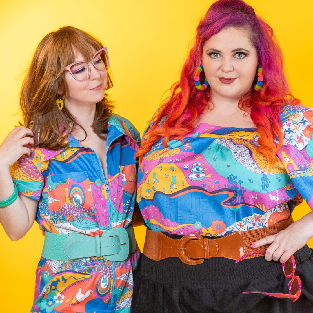 Closeup of 2 models wearing colorful clothing printed with animals and other elements