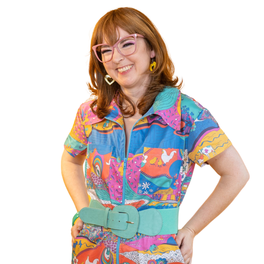 Happy model wearing sunglasses and bright colored printed jumpsuit