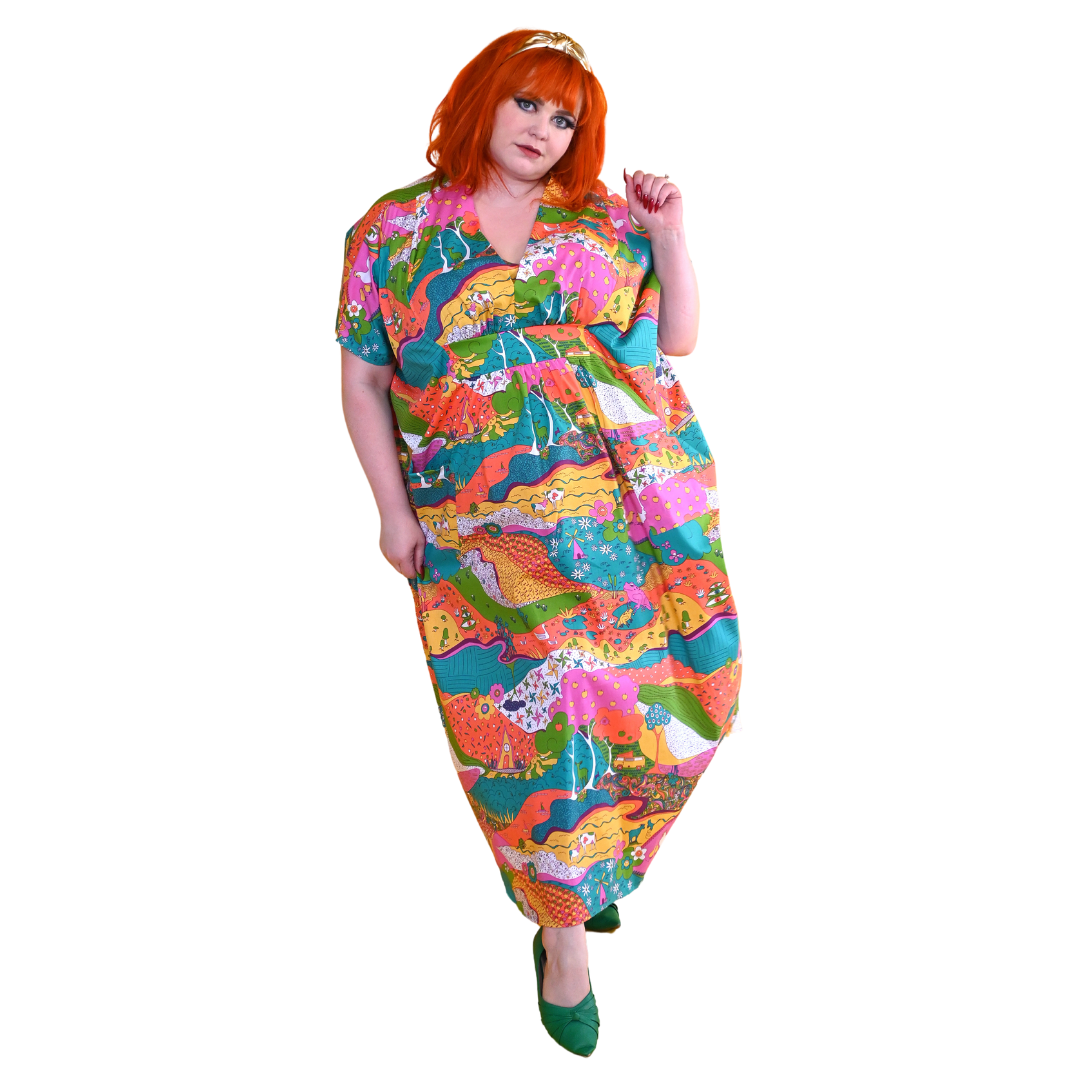 Red-haired model in bright, colorful printed caftan dress