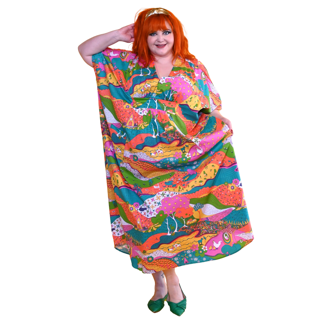 Red-haired model in bright, colorful printed caftan dress