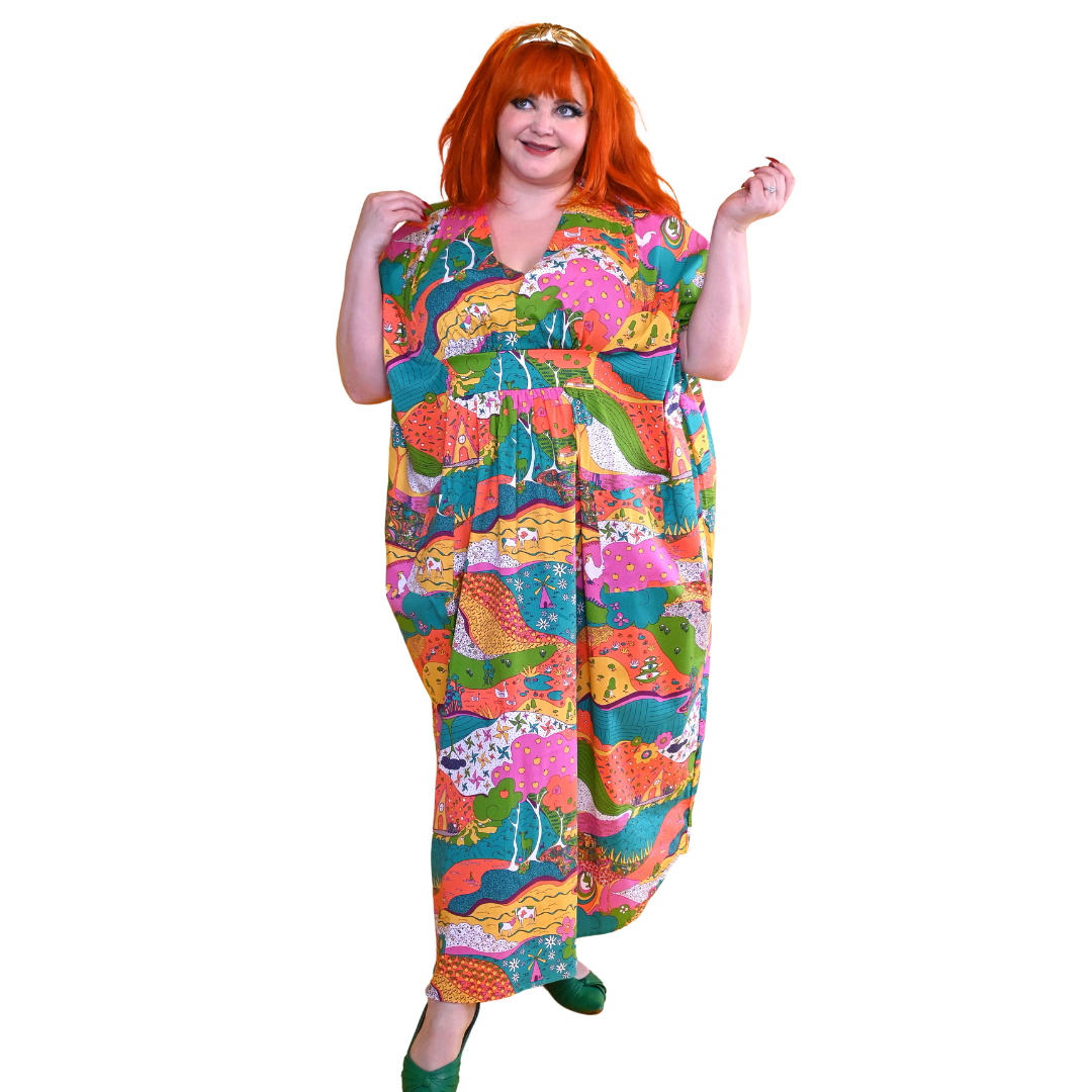 Red-haired model in bright, colorful printed caftan dress