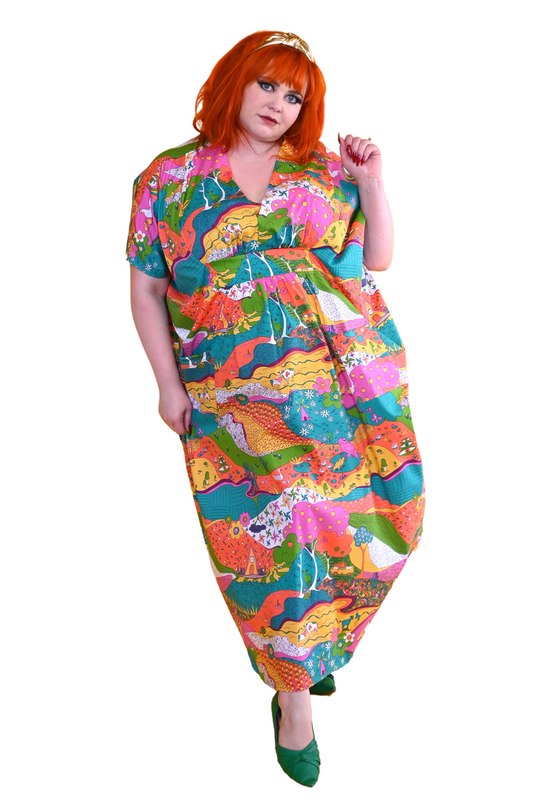 Red-haired model in bright, colorful printed caftan dress