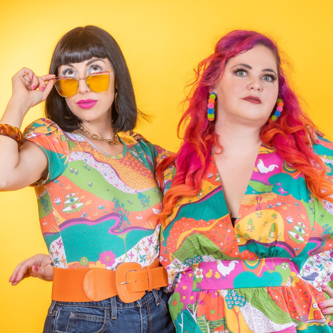 Closeup of 2 gorgeous models in bright, colorful printed clothing