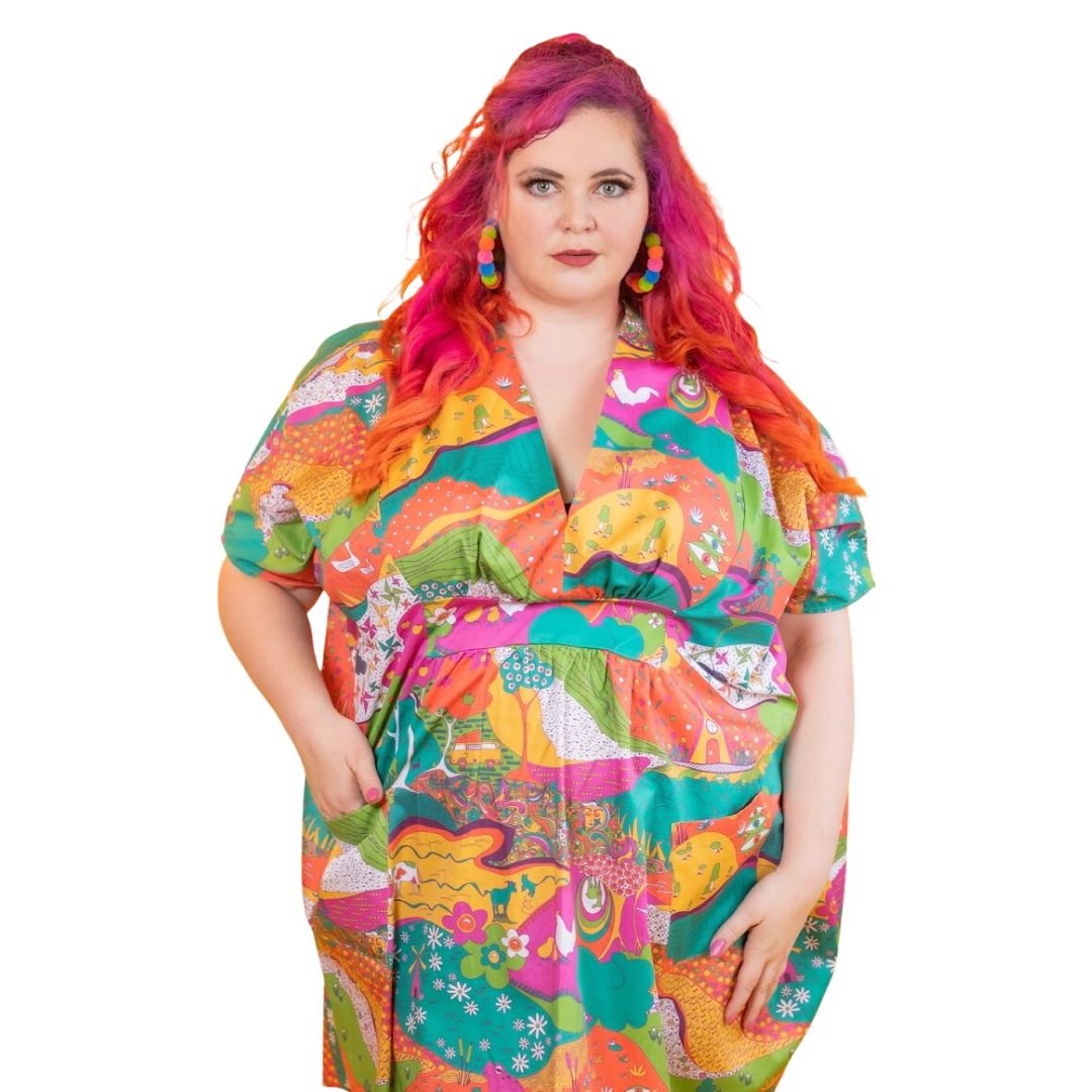 Pink-haired model in bright , colorful caftan