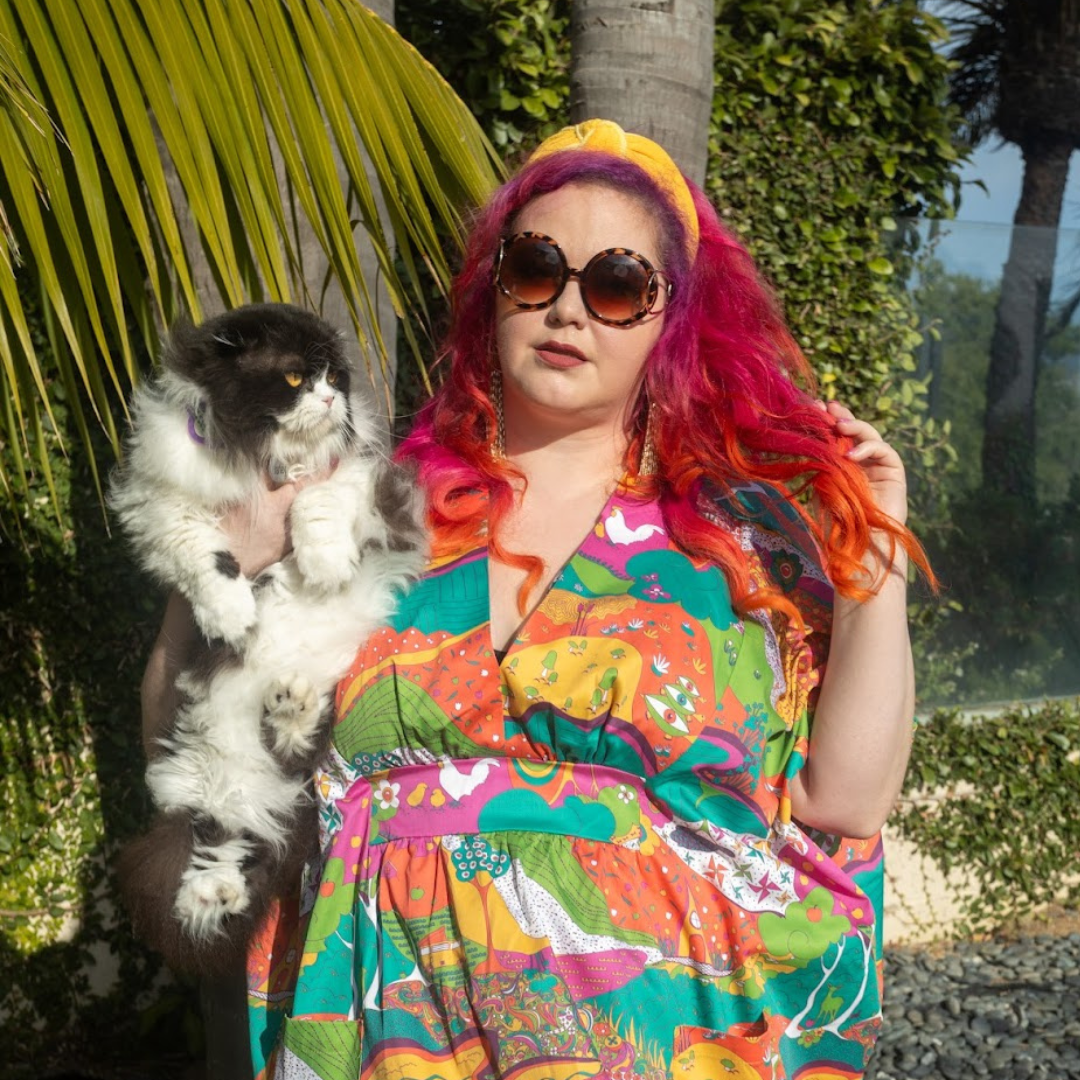 Pink-haired model in bright , colorful caftan