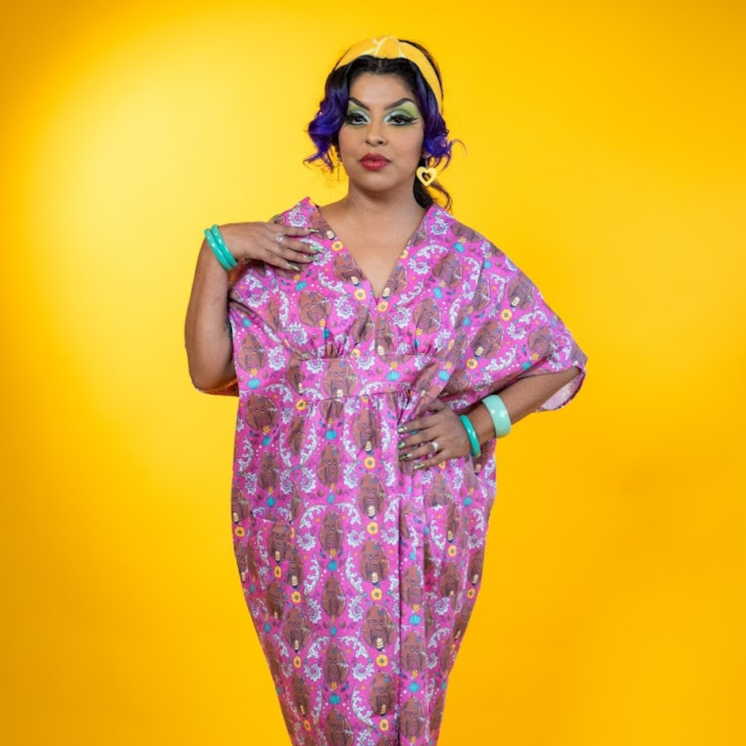 Woman in long pink monkey print caftan