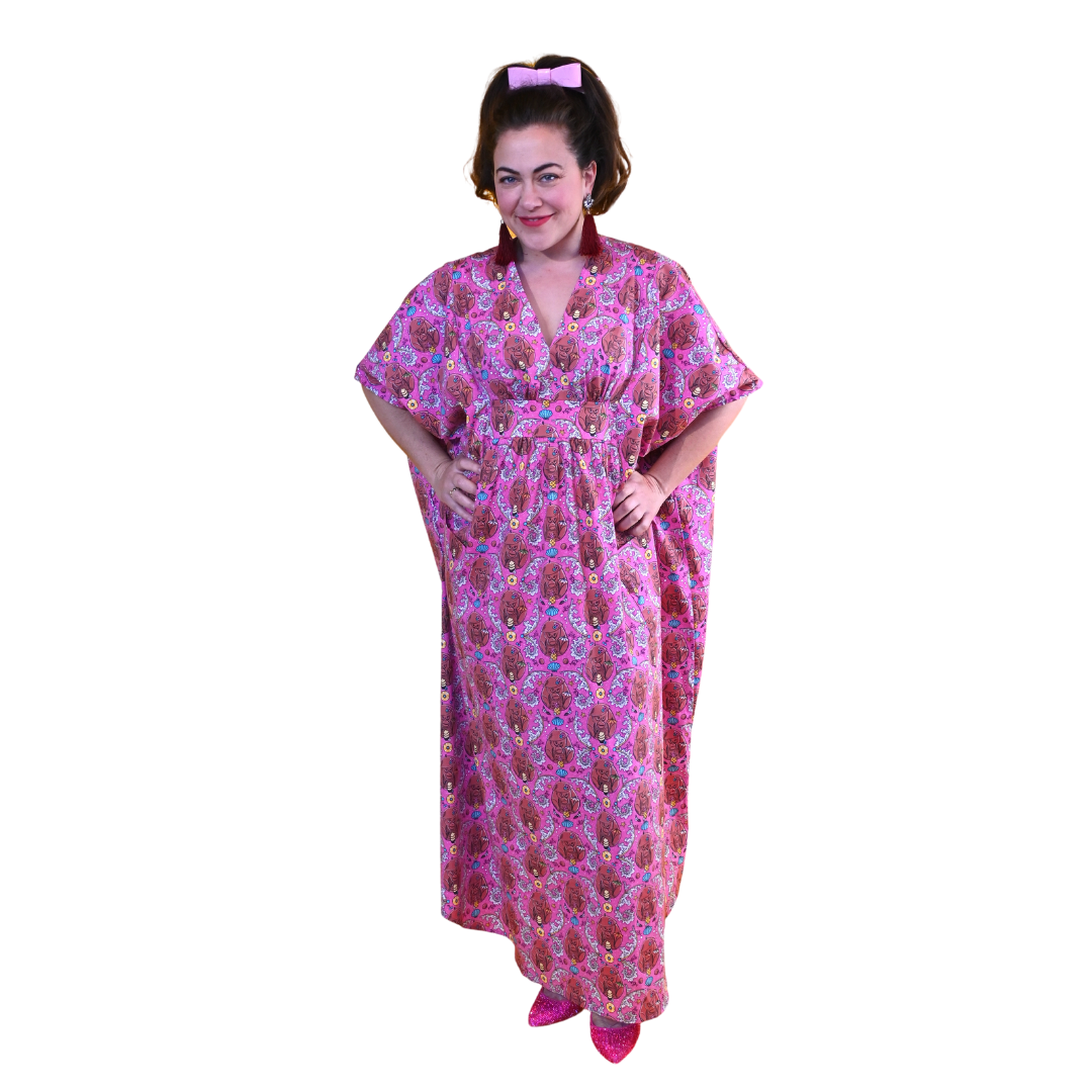 Full length pic of woman in magenta monkey print caftan
