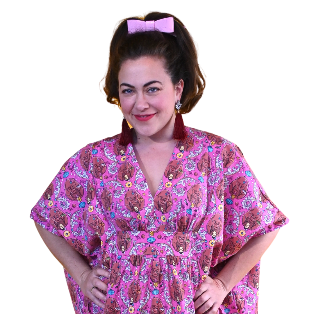 Closeup of model in magenta monkey print caftan