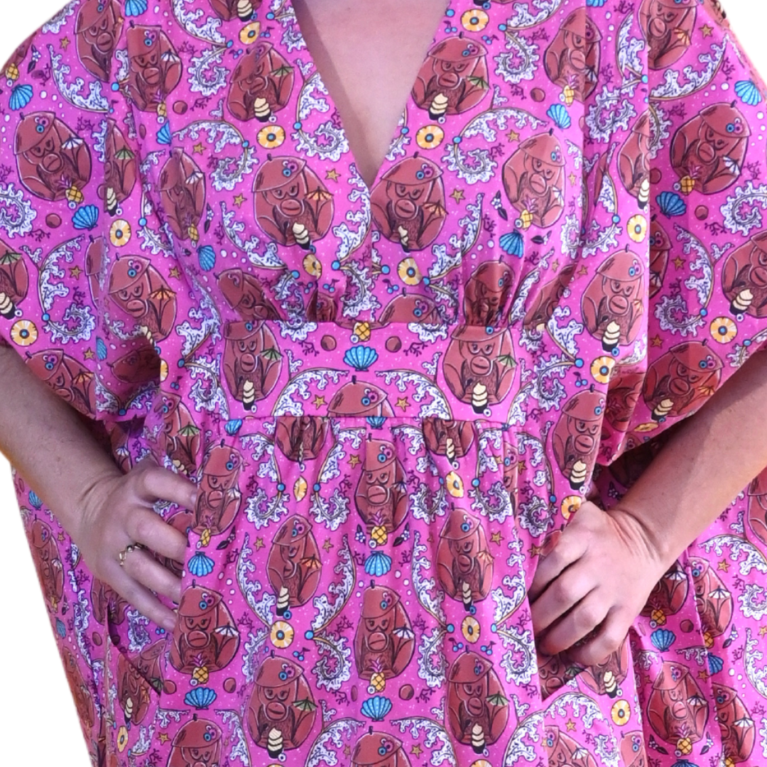 Closeup of woman in long pink monkey print caftan