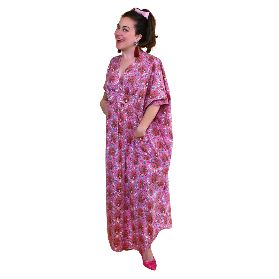 Woman in long pink monkey print caftan