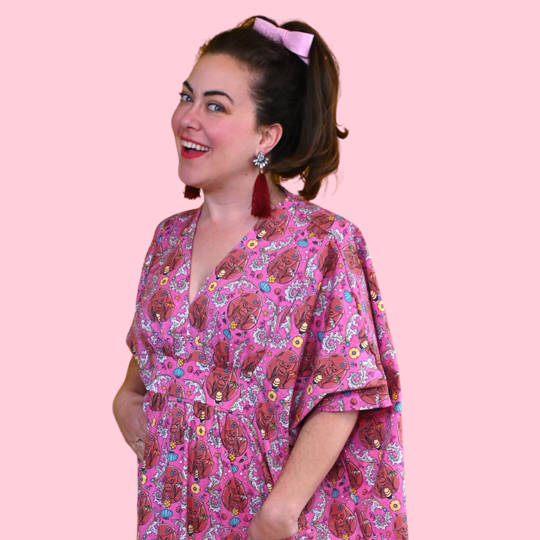 Closeup of woman in long pink monkey print caftan