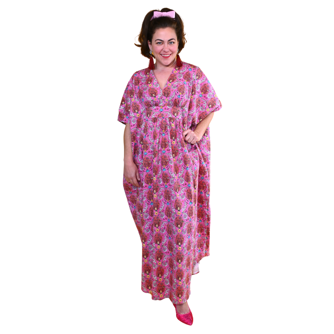 Model in magenta monkey print caftan