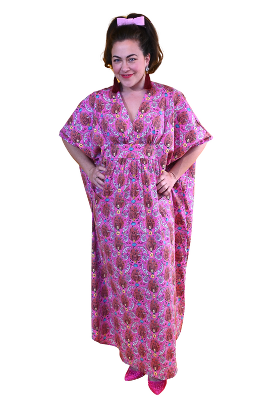 Woman in long pink monkey print caftan