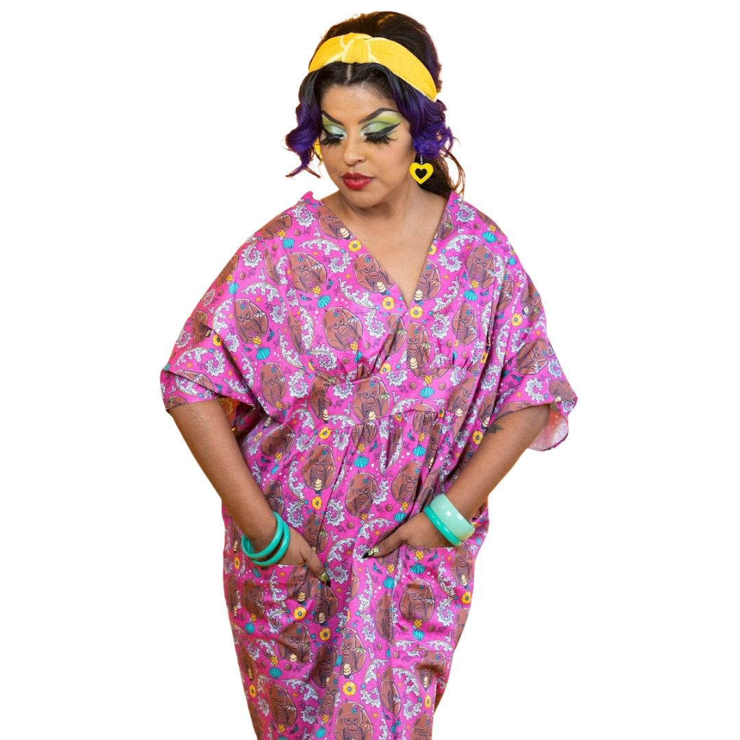 Model in pink monkey caftan with yellow headband