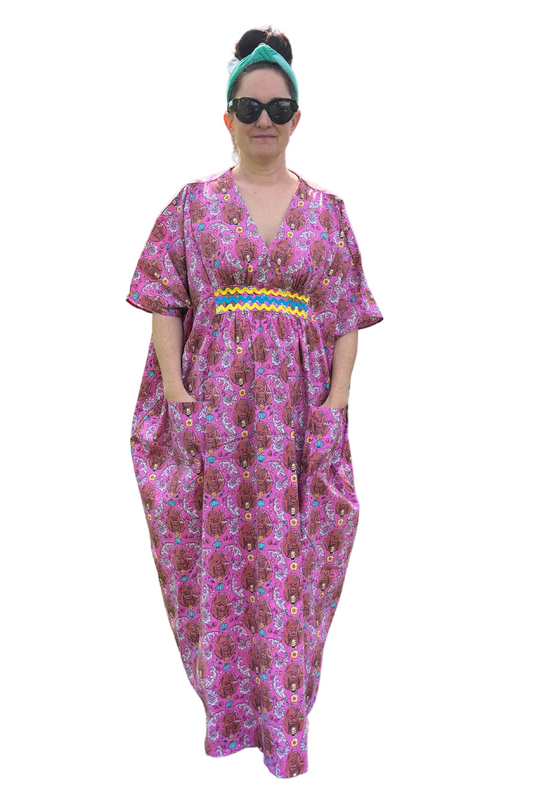Woman with sunglasses in pink monkey print caftan with ricrac trim