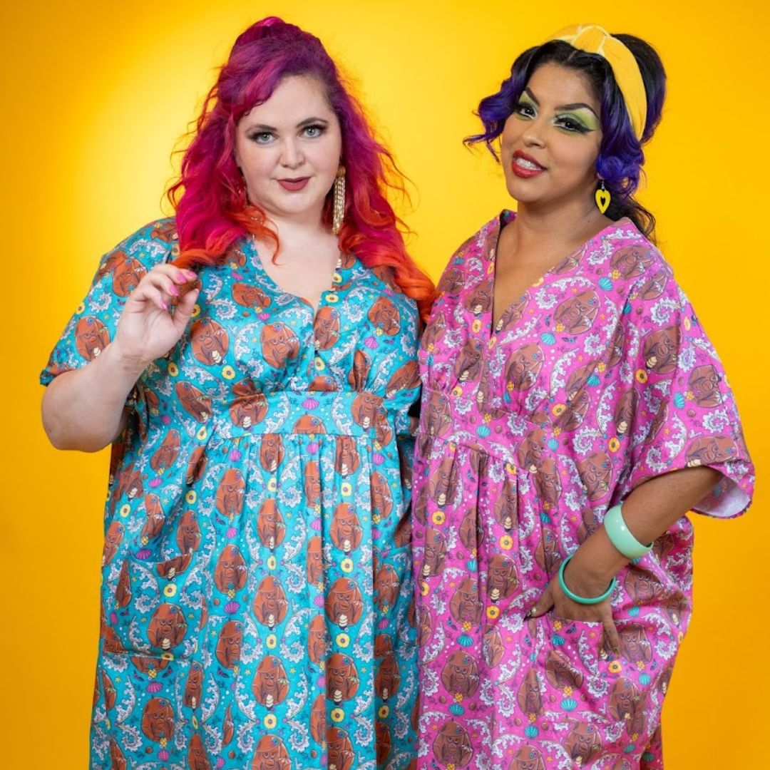 2 models in colorful monkey print caftans