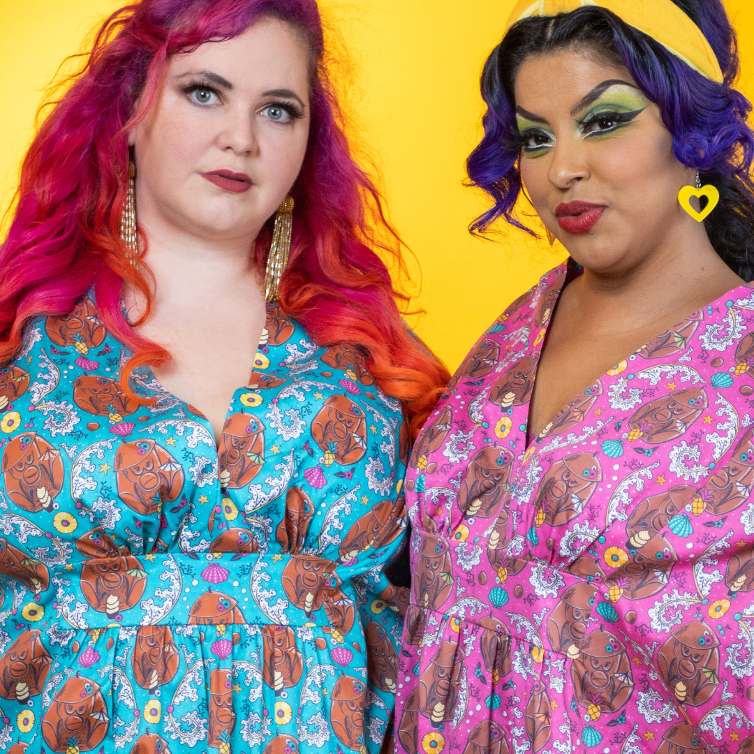 2 models in colorful monkey print caftans