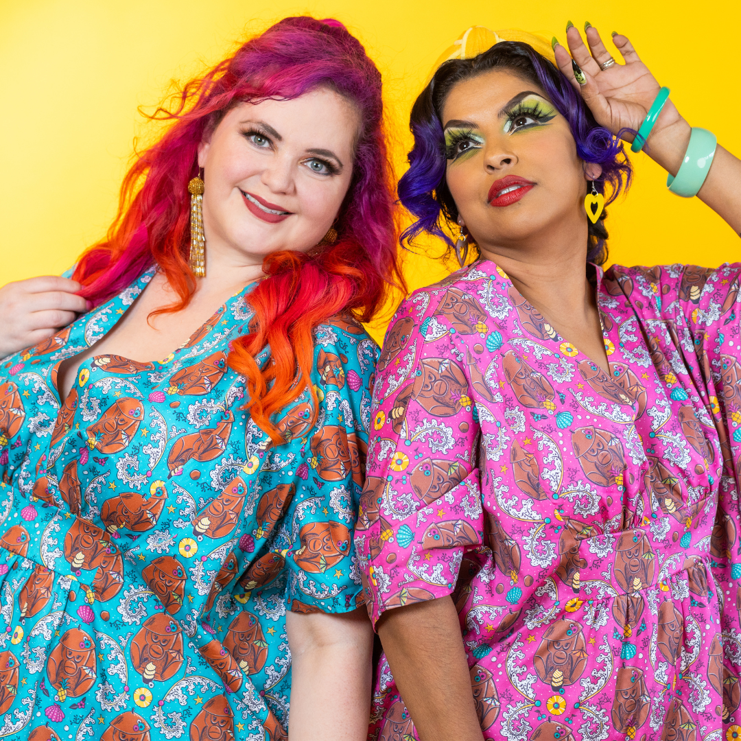2 models posing dramatically in monkey caftans
