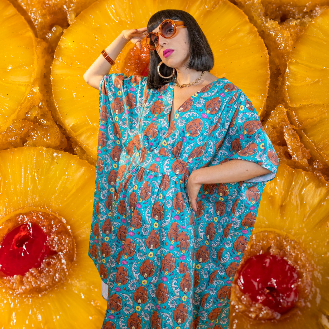Tall dark-haired model with sunglasses in monkey caftan