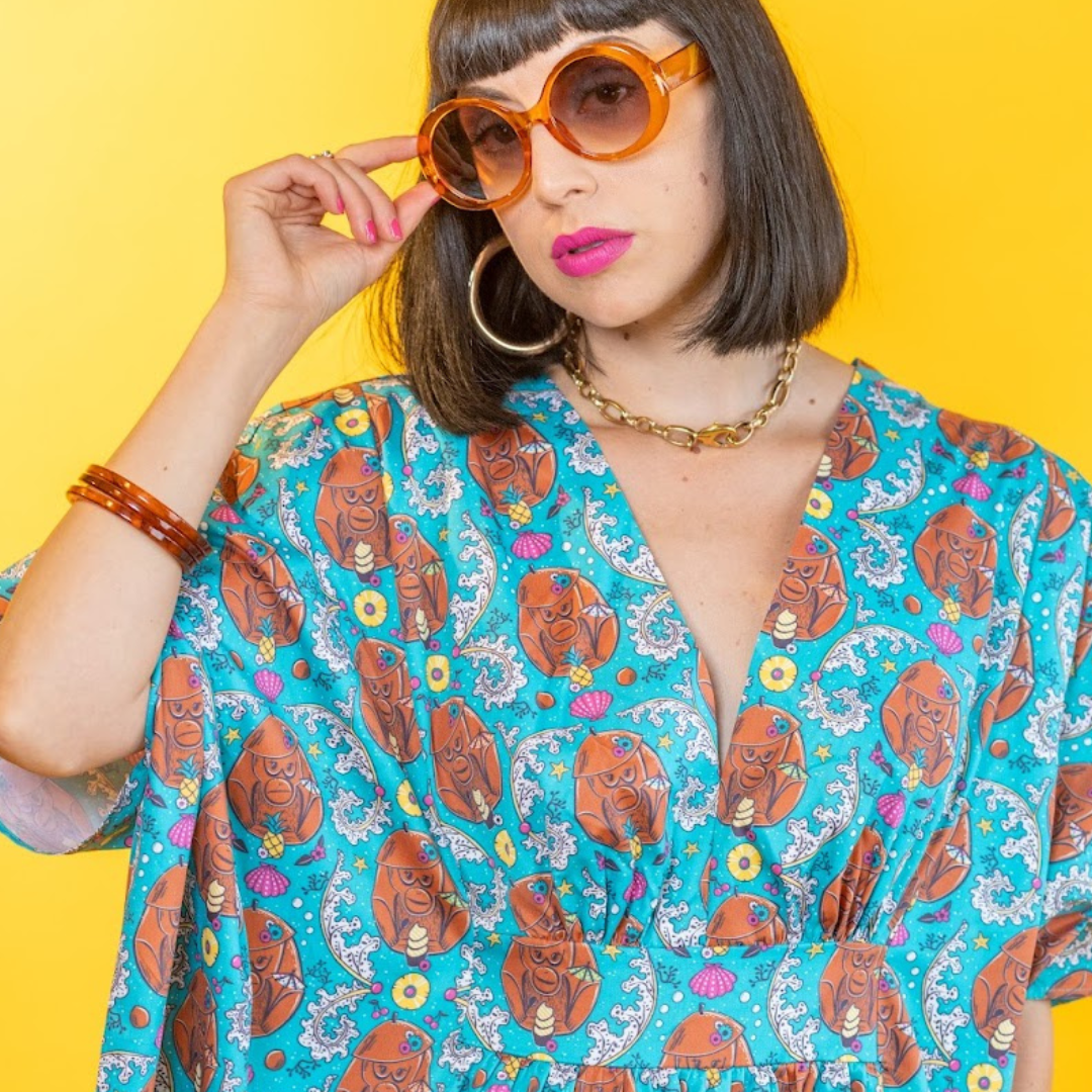 Dark-haired model in teal monkey print cotton caftan