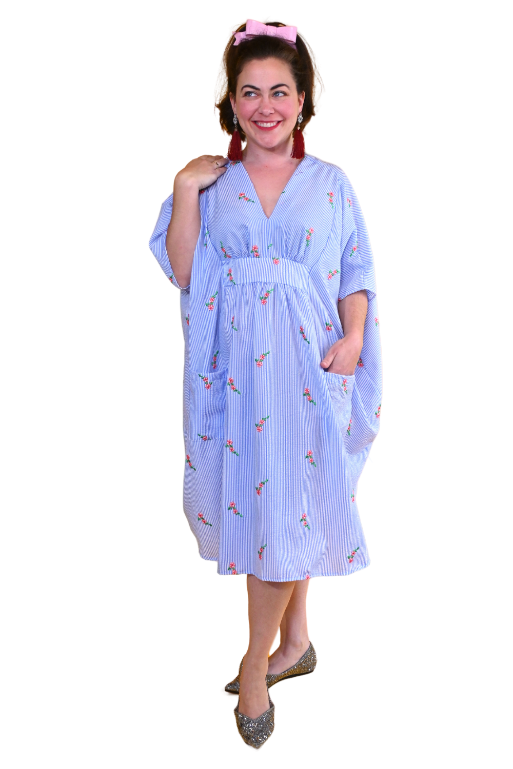 Cute model in blue and white seersucker caftan with embroidered flowers
