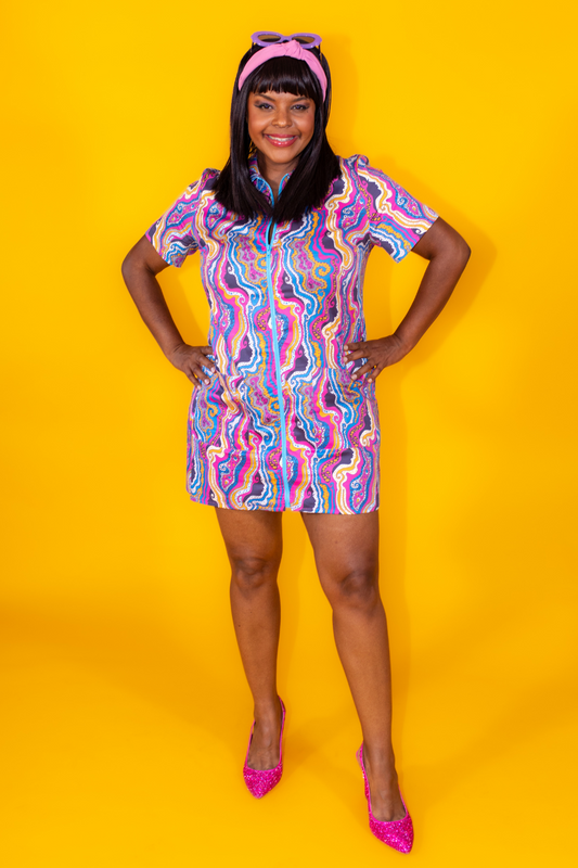 Pretty Black girl wearing bright psychedelic print minidress