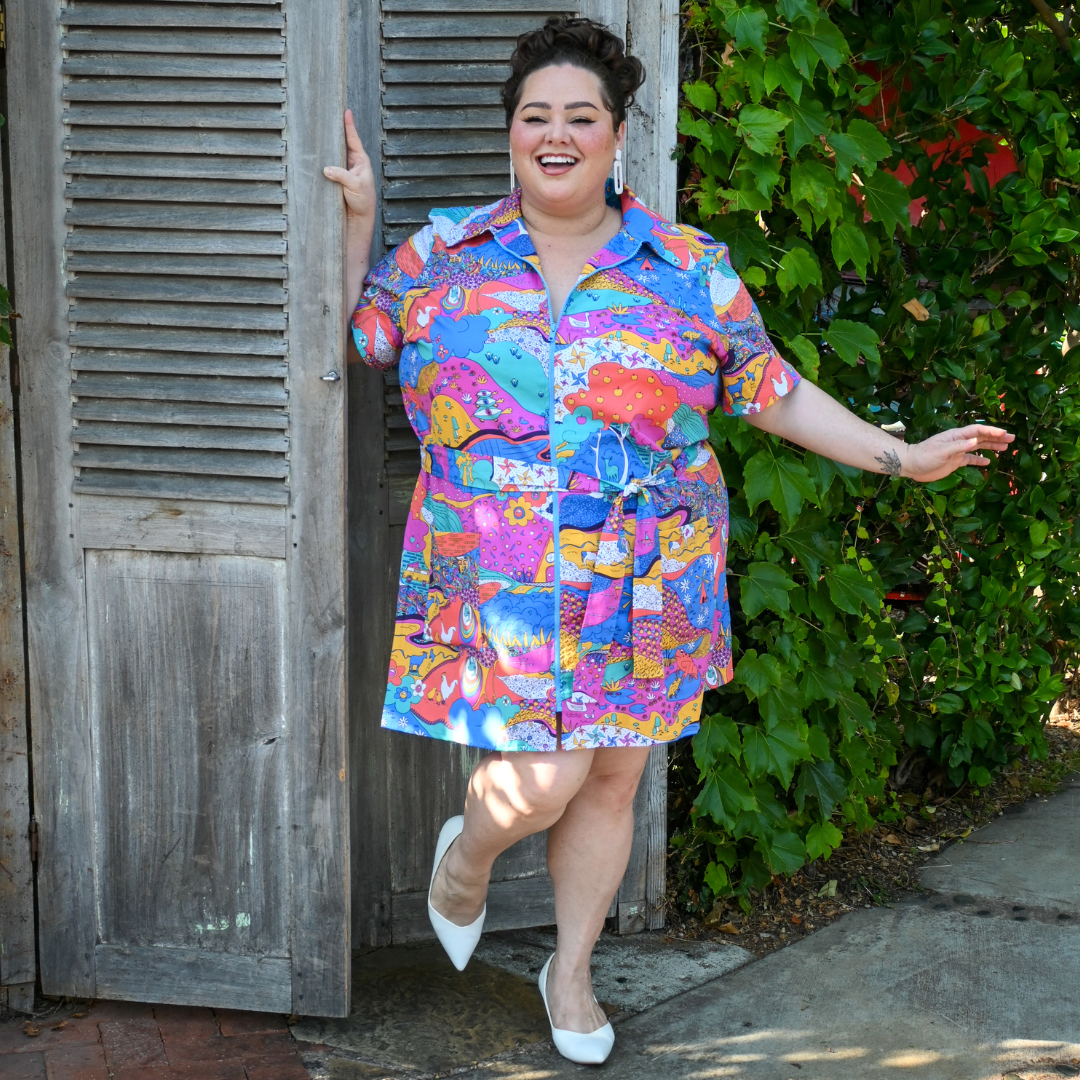 Smiling model in landscape print minidress