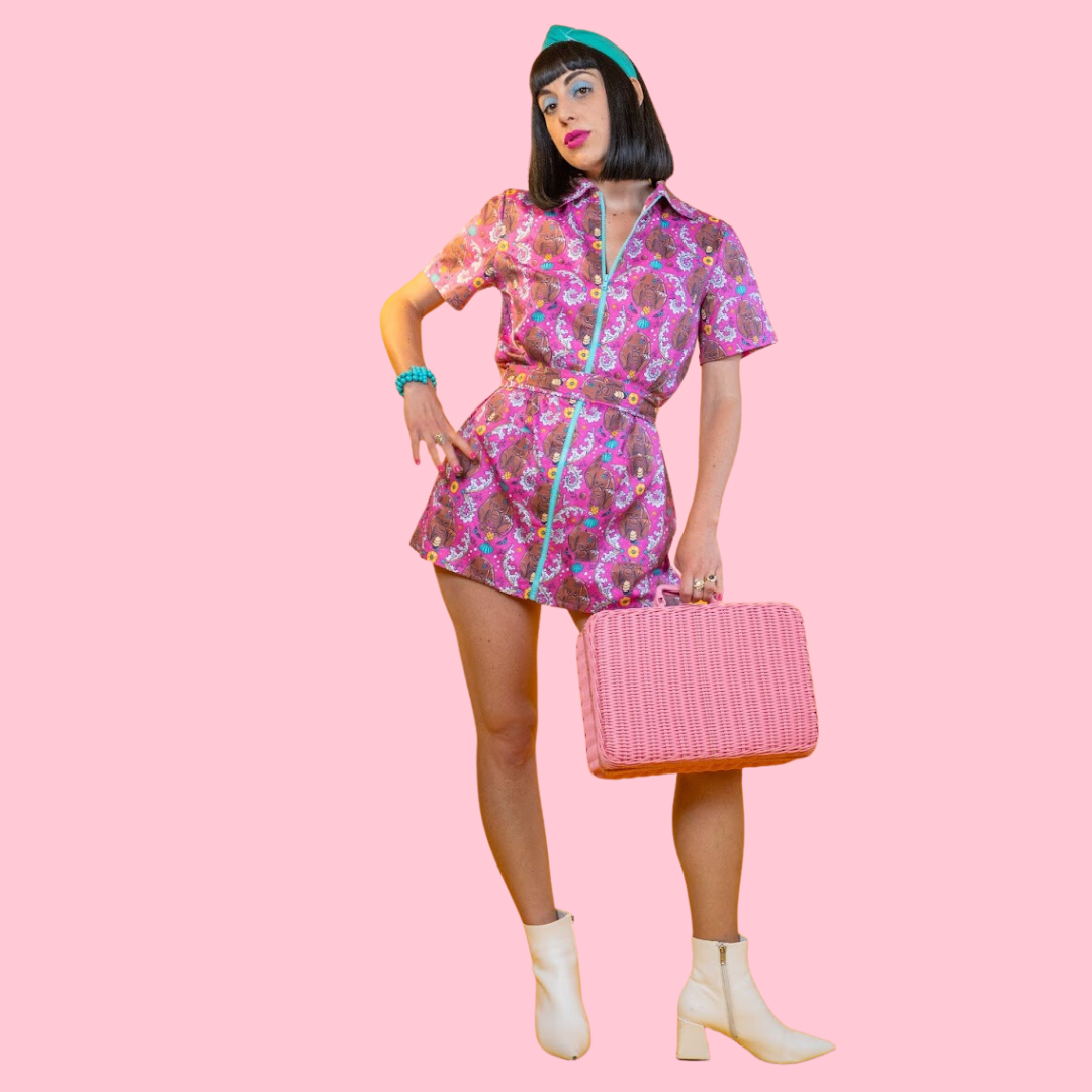 Model wearing tiki print zip-front dress accentuated with bold accents