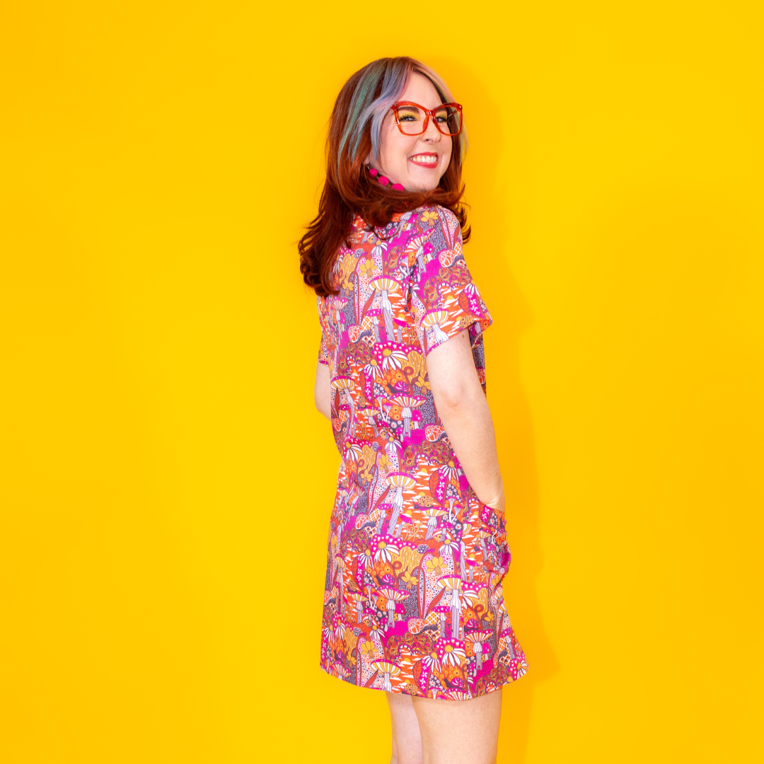 Side view of model in glasses and mushroom print minidress