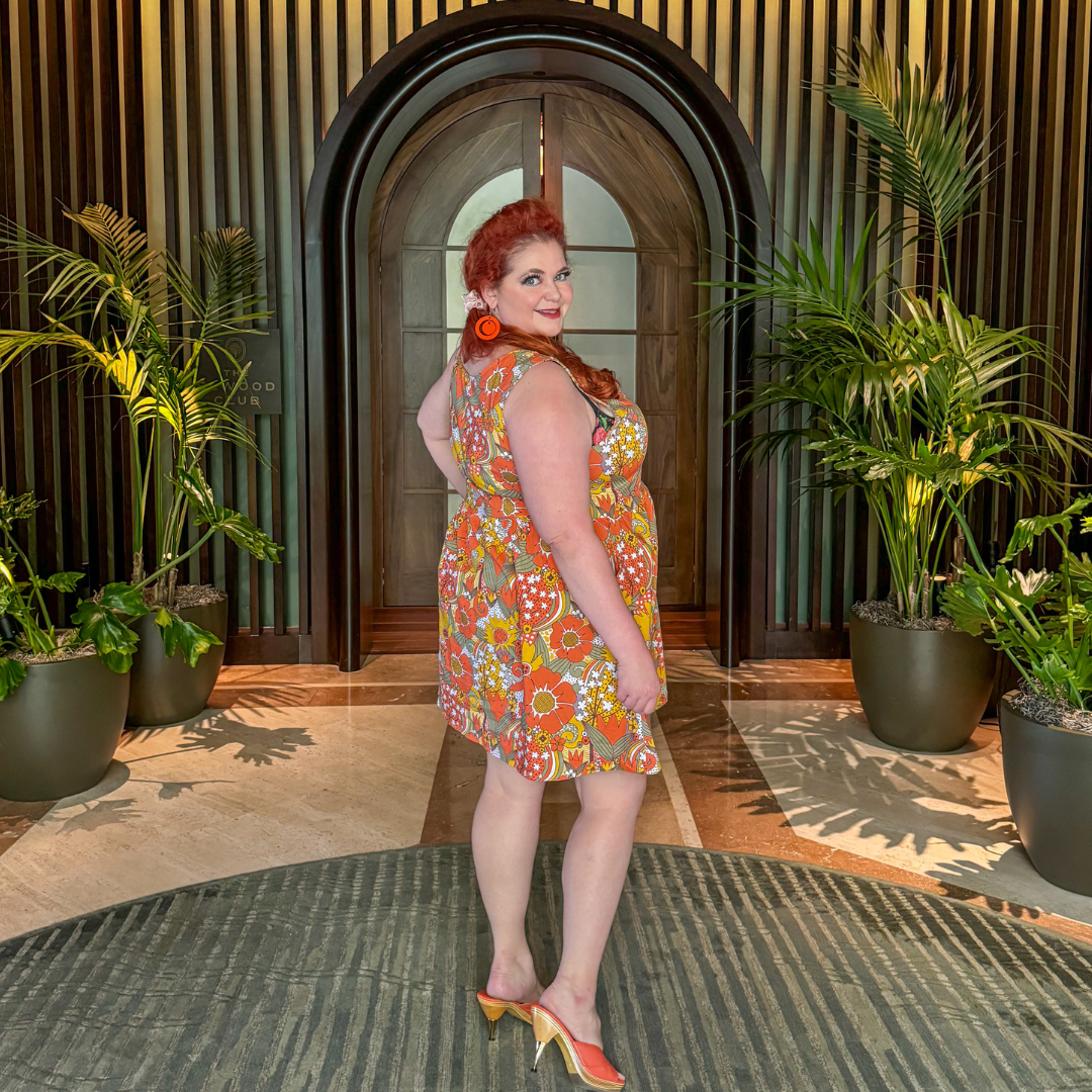 Side view of red haired model in groovy floral dress