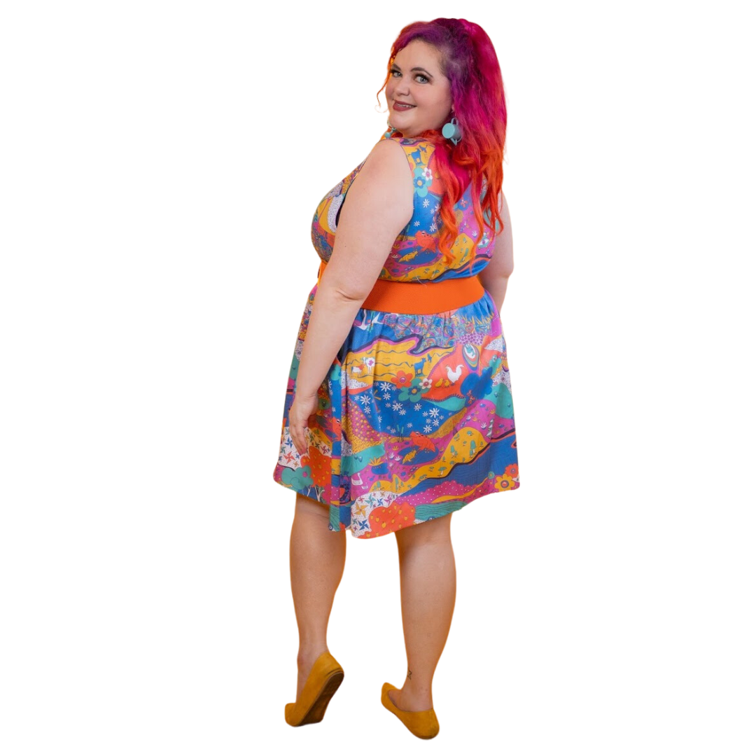 Back view of model in landscape-print dress featuring animals