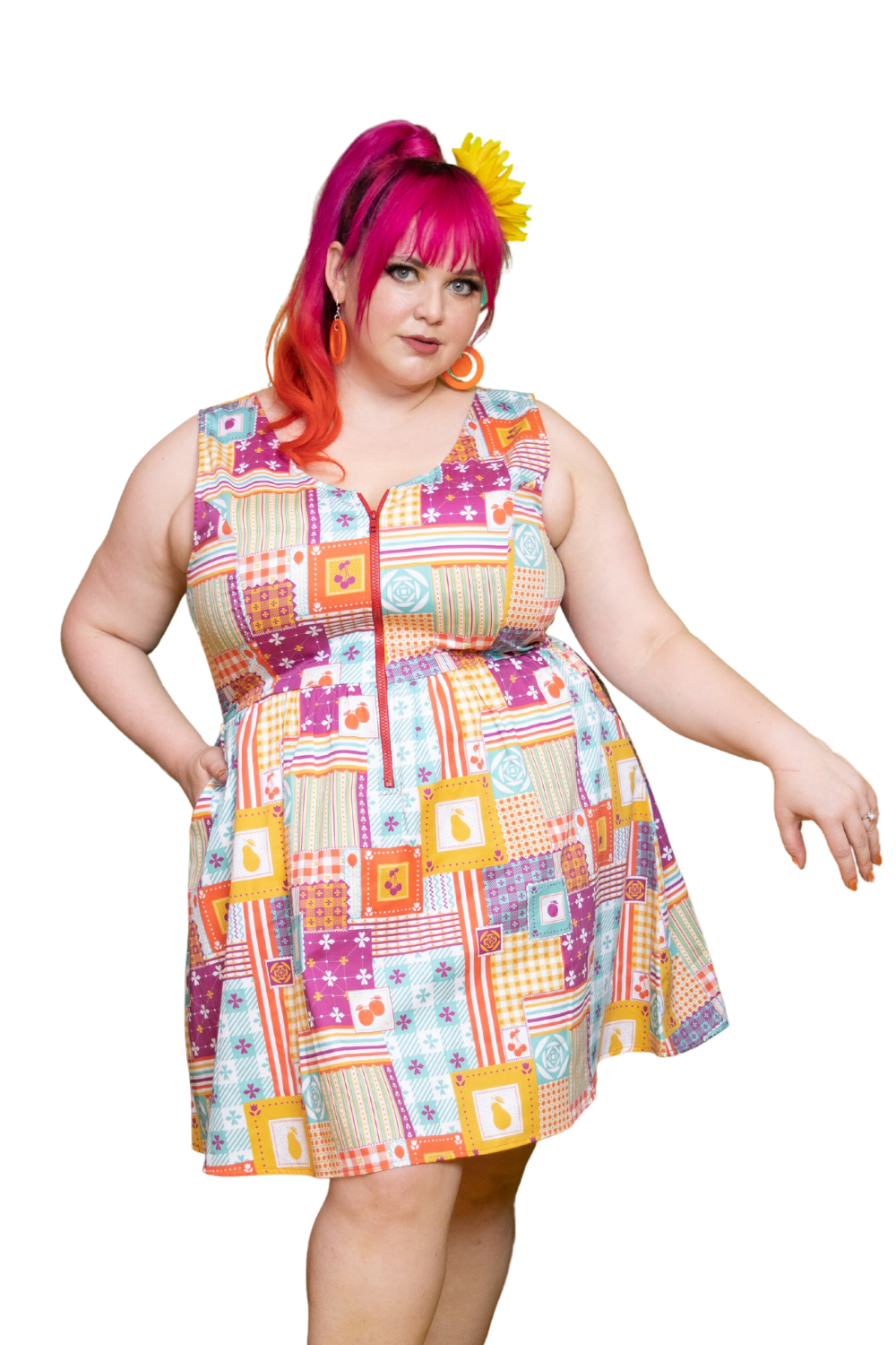 Pink haired model wearing colorful dress with a patchwork design