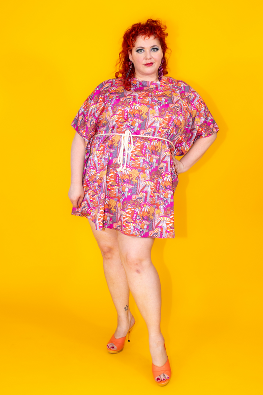 Red-haired model in mushroom print mini muumuu
