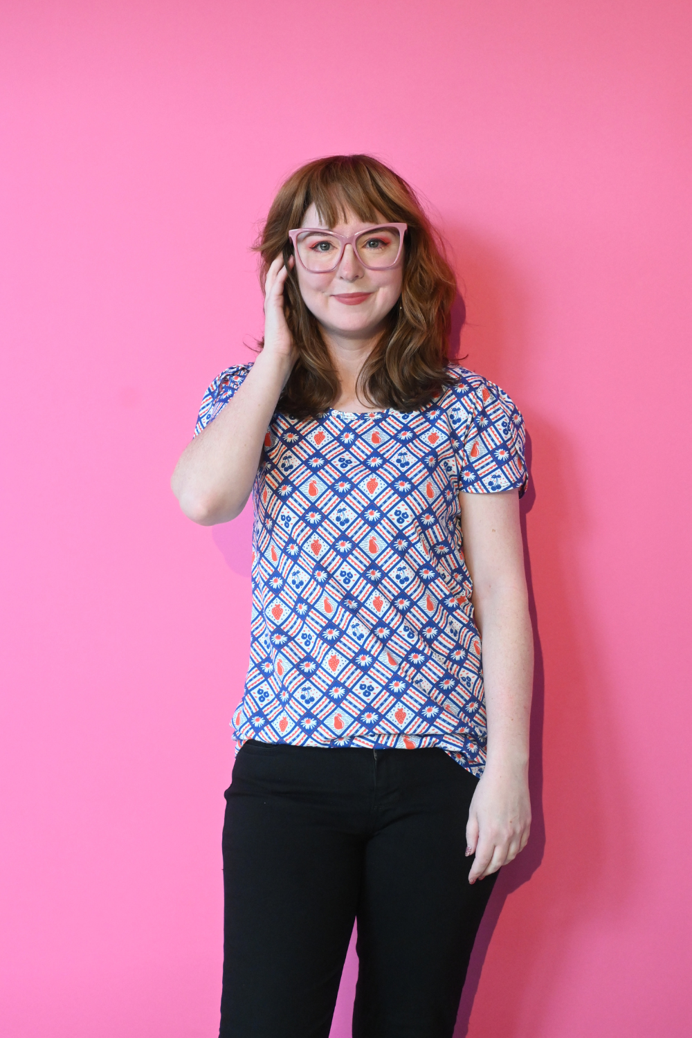 Girl with glasses in red and navy fruit and gingham print tee