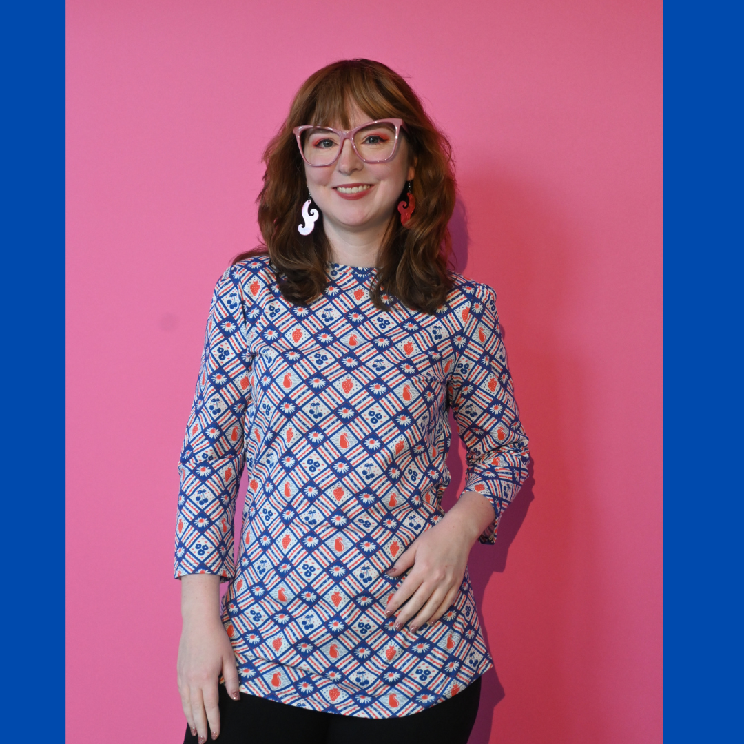 Navy blue red fruit flower plaid graphic tee on brown haired model with cute earrings