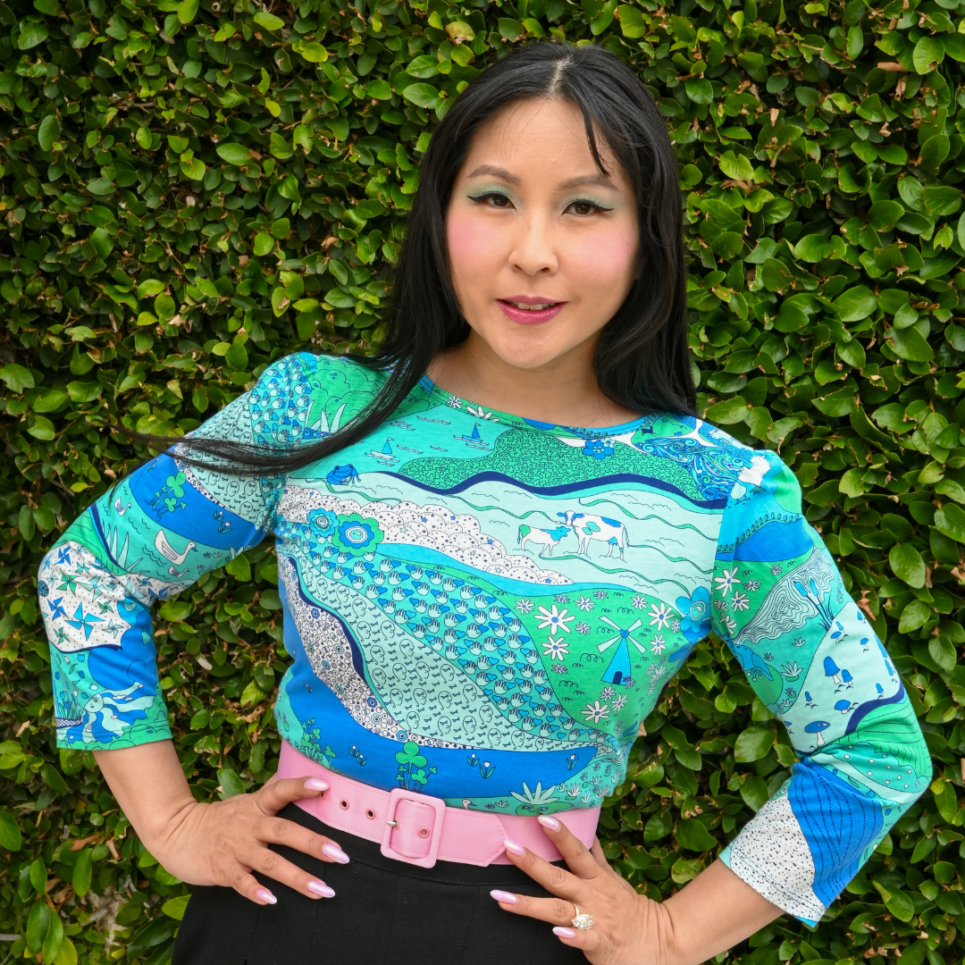 Pretty Asian model in landscape print 3/4 sleeve tee in blue and green tones