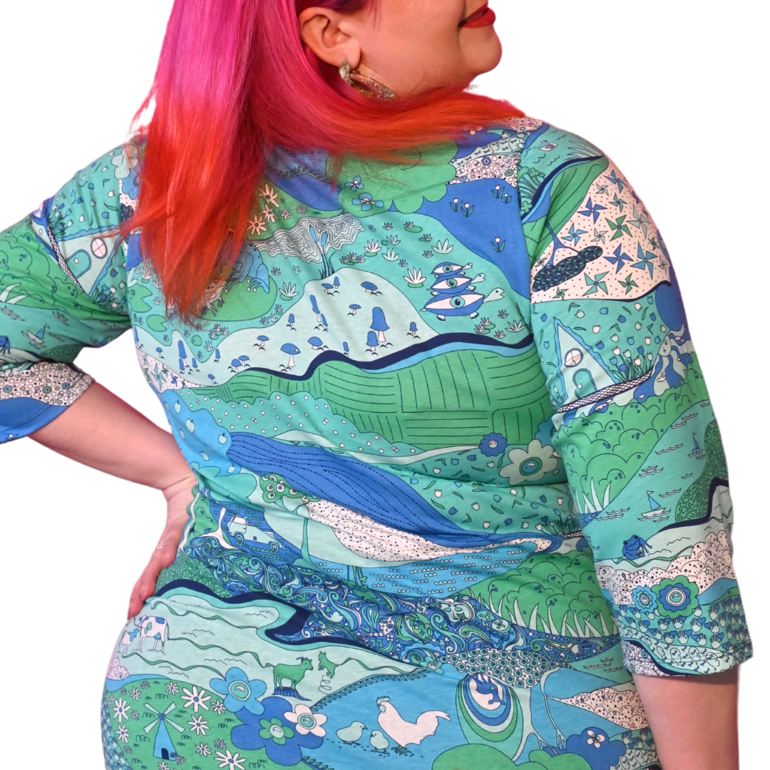 Back view of plus sized blue green graphic landscape print tee