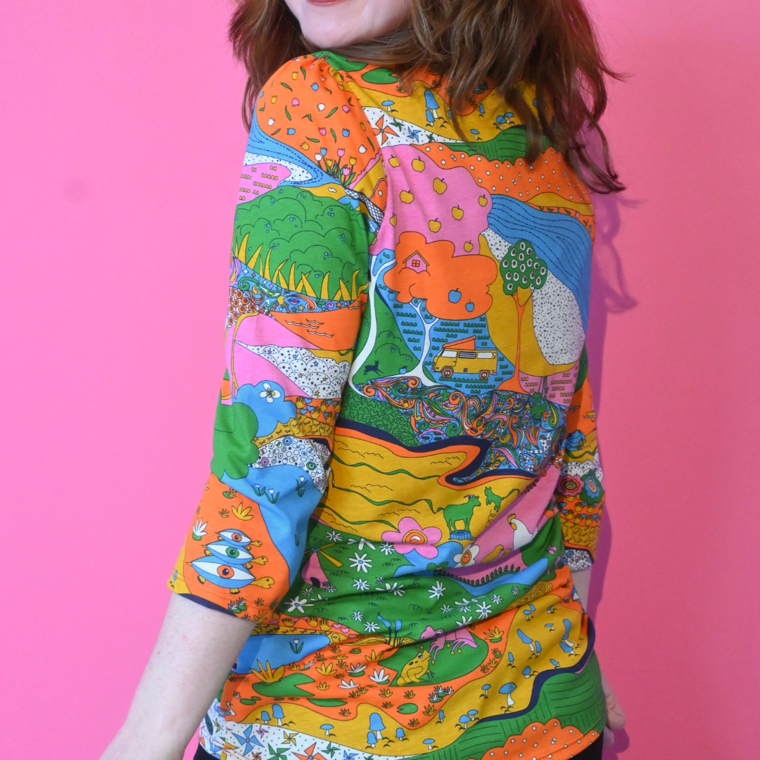 Back view of landscape print tee in rainbow