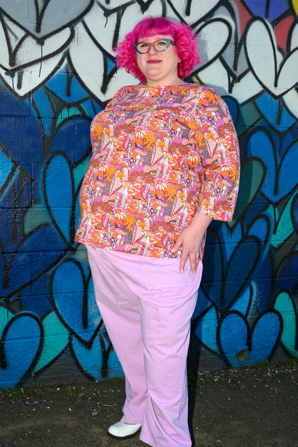 Pink-haired model in mushroom print 3/4 sleeve tee