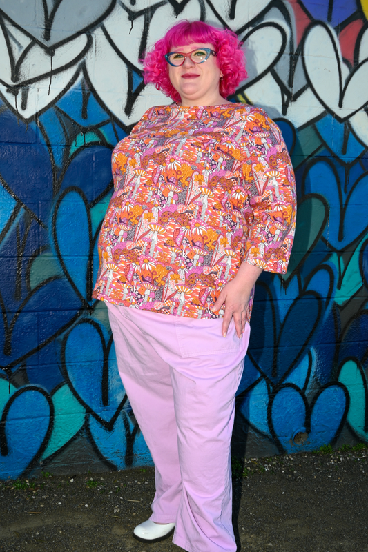 Pink-haired model in mushroom print 3/4 sleeve tee