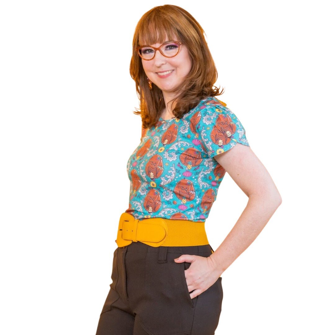Cute smiling model in coconut monkey and pineapple print tiki tulip sleeve tee