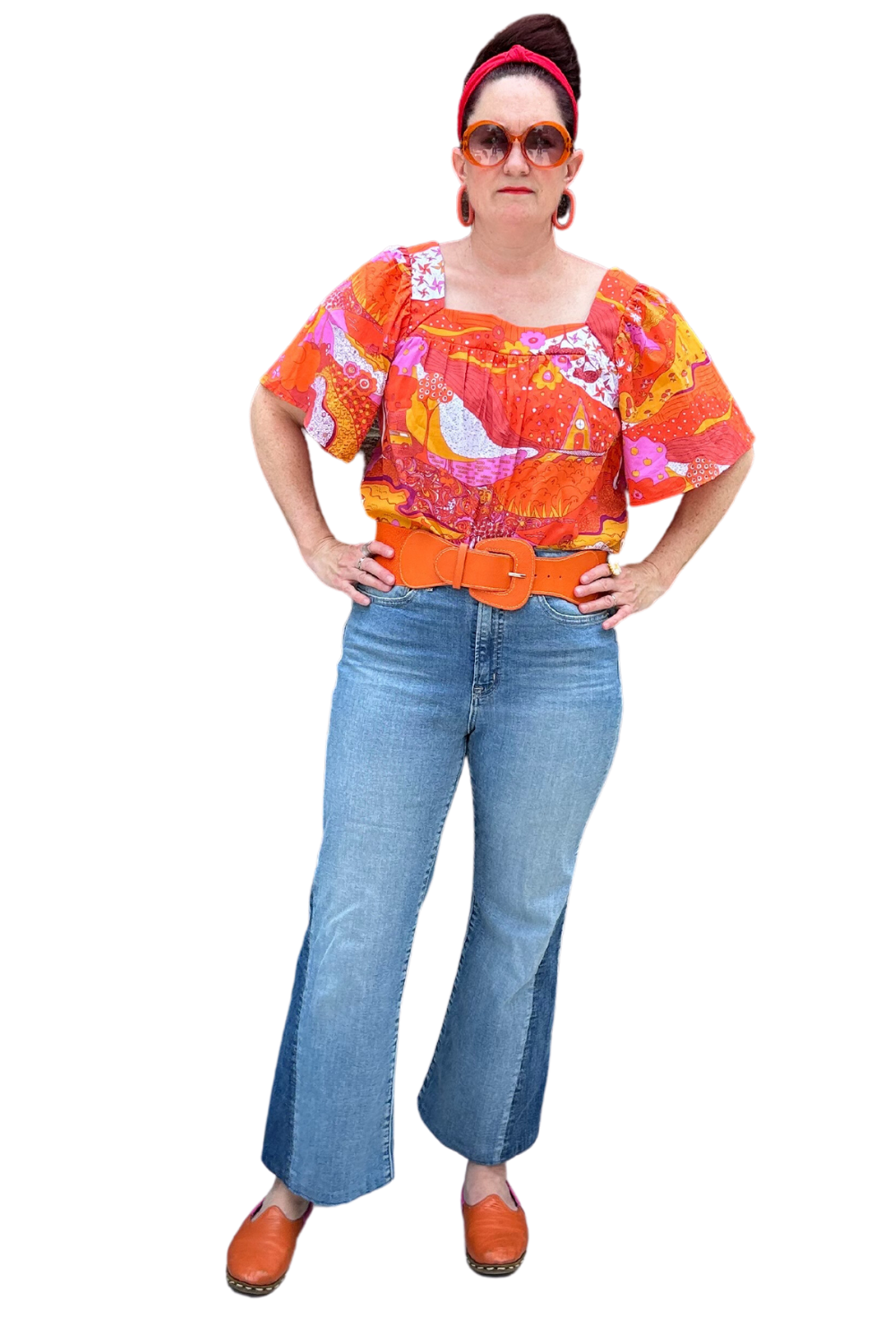 Model in brightly colored woven square-neck top with landscape print in pink, orange and yellow