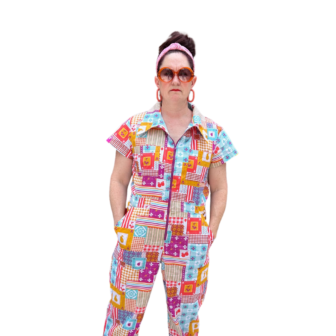 Model wearing sunglasses and patchwork print zip-front collared jumpsuit