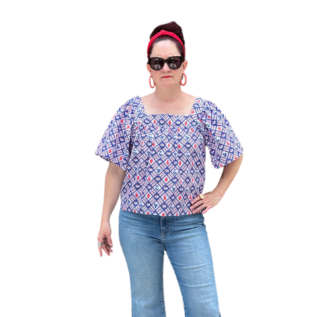Square neck peasant top with blue and red print and graphic of fruit and flowers