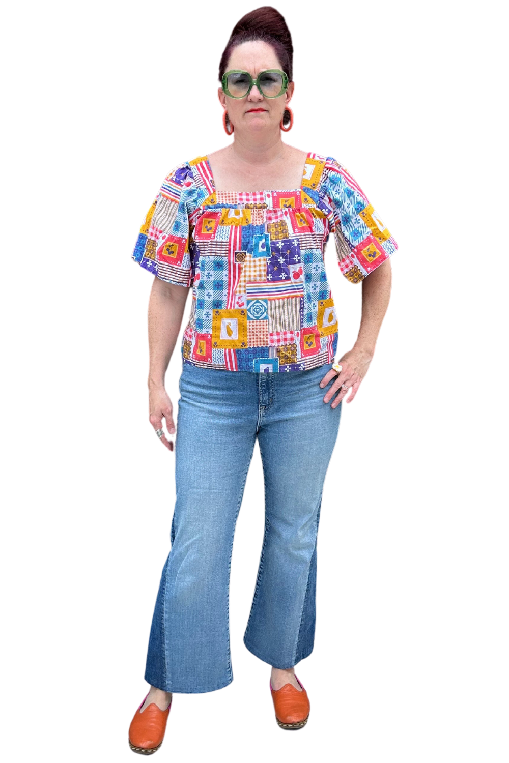 Model in blue red yellow patchwork print square neck top and jeans